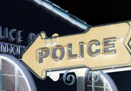 police-sign-with-building-crop-small-inverse
